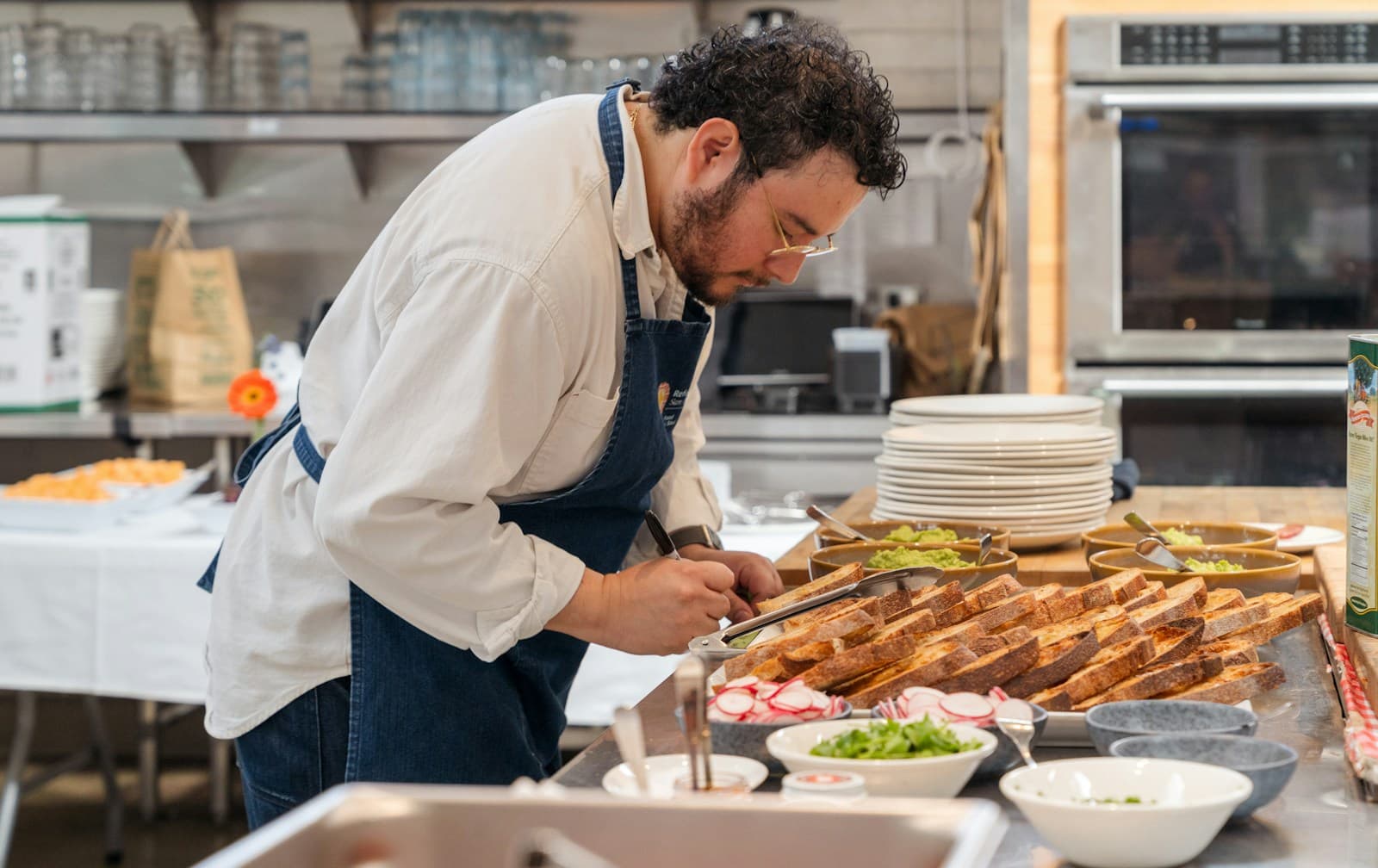 Chef checking a preparation list at a restaurant counter before service